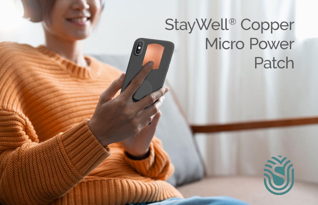 StayWell Copper Micro Power Patch shows Lady holding phone case with 2" x 1.125" Adhesive Phone Patch made in USA from natural antimicrobial copper attaches to germy devices we touch most. Sanitizers, Chemical Free, Lasts Forever. Recyclable. Kills 99.9% of Harmful Bacteria. EPA registered.